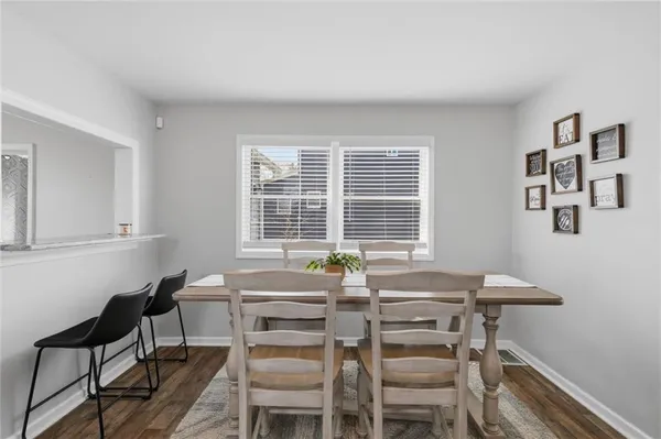 a view of a dining room with furniture and windows