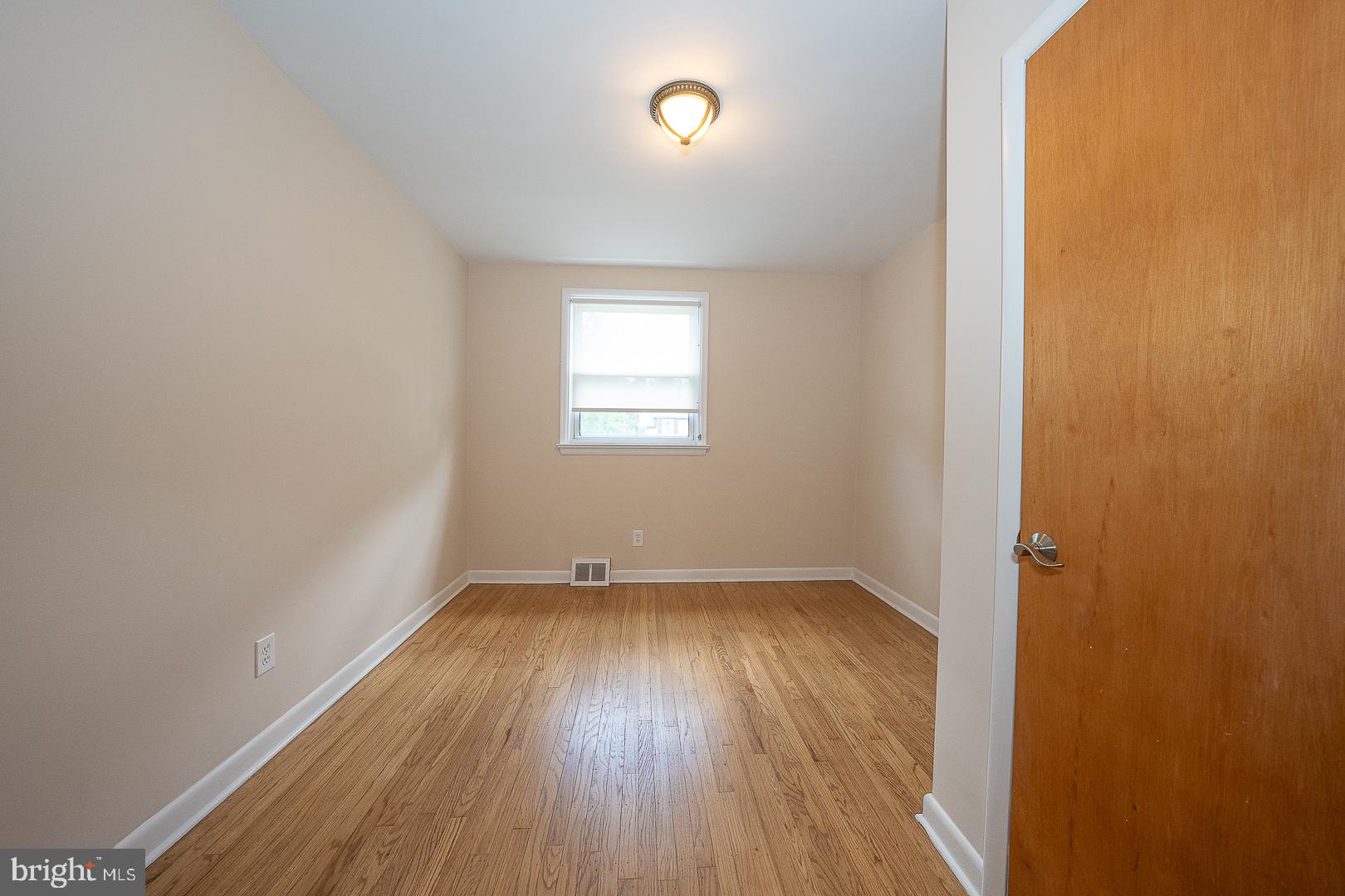 20 Fairview Road Swarthmore, PA 19081 - Photo 20 of 57 an empty room with wooden floor and windows