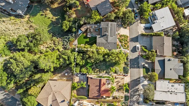 an aerial view of a house with a mountain
