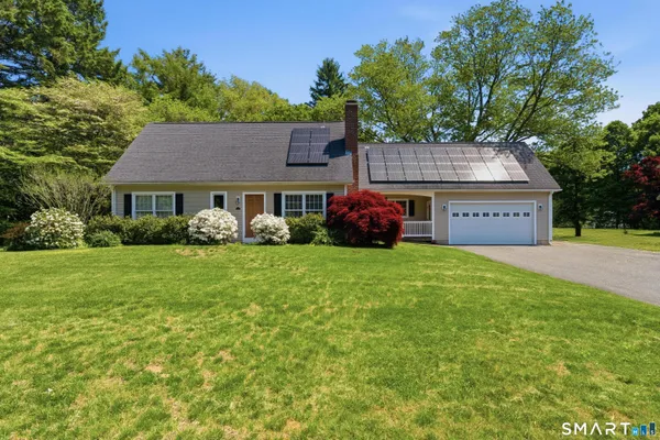 a front view of a house with garden