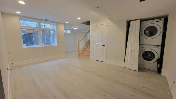 a view of a hallway with washer and dryer
