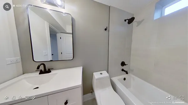 a bathroom with a tub sink vanity and mirror