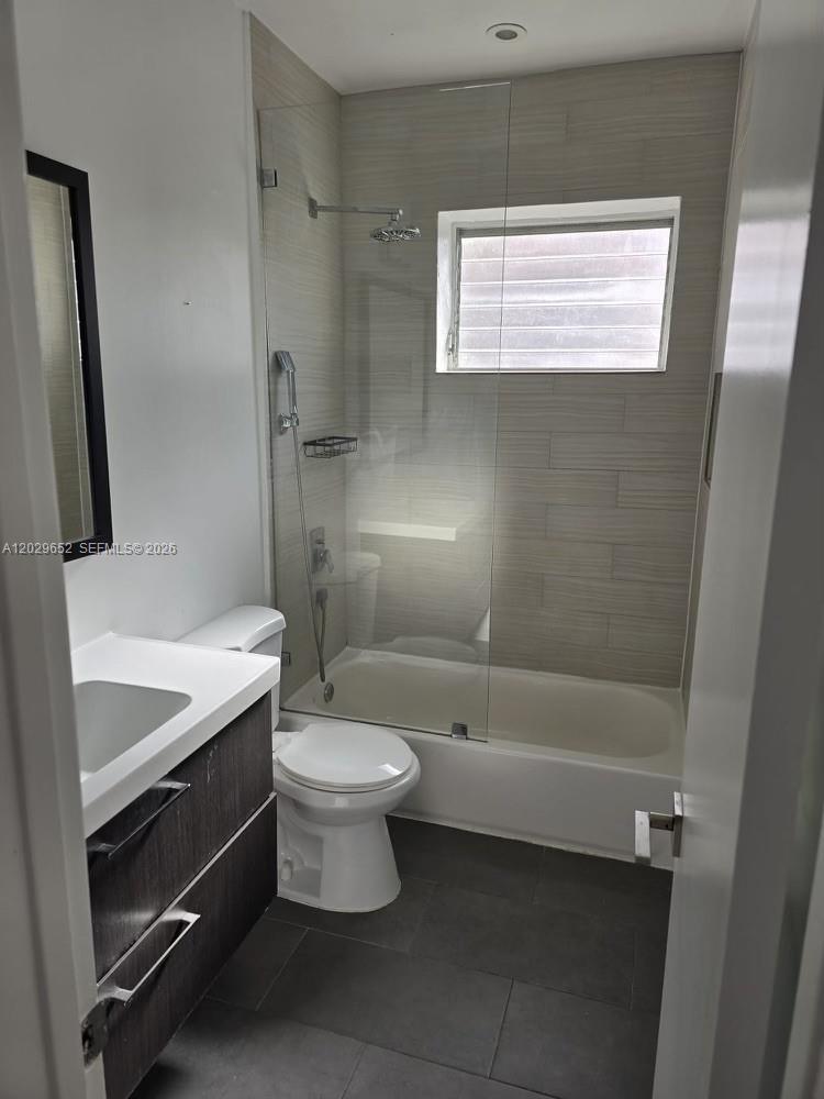 855 80th Street, Unit 4 Miami Beach, FL 33141 - Photo 14 of 16 a bathroom with a sink a toilet and shower