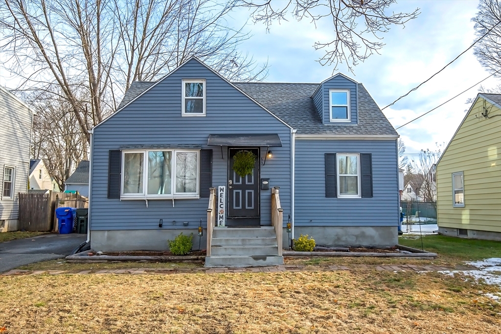 65 Garland Street Springfield, MA 01118 - Photo 1 of 39 a brick house that has a small yard and large trees