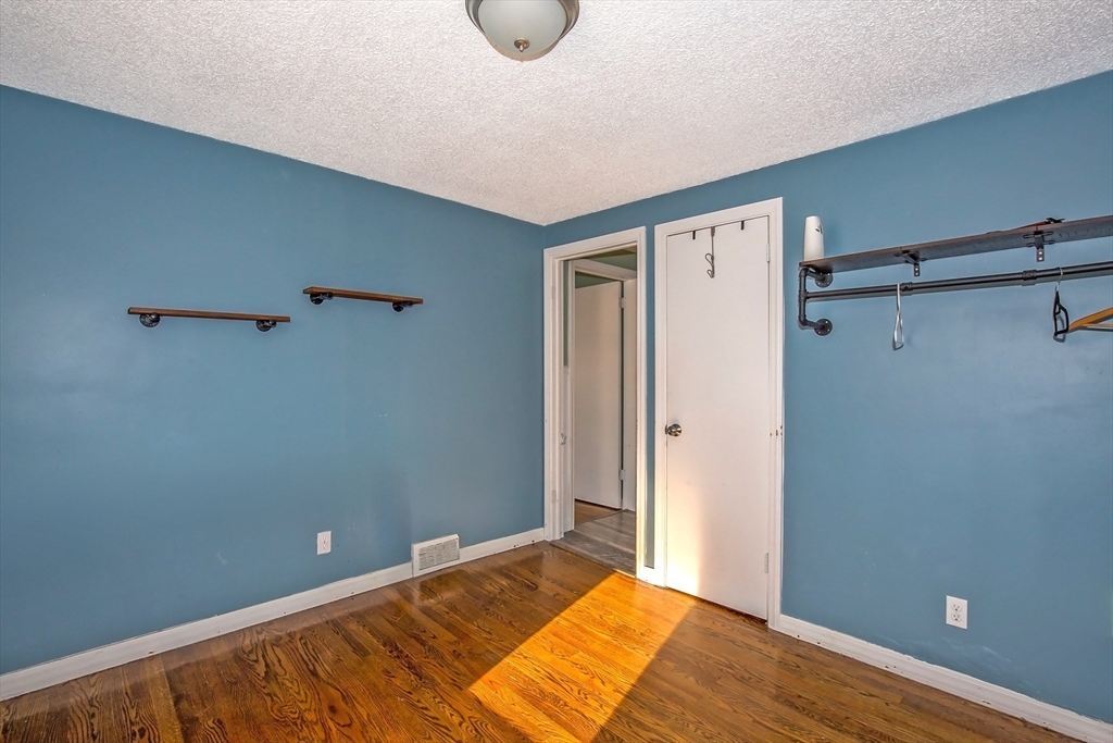 65 Garland Street Springfield, MA 01118 - Photo 13 of 39 a view of a room with wooden floor and bathroom