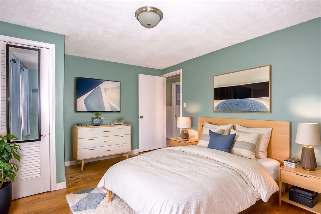65 Garland Street Springfield, MA 01118 - Photo 20 of 39 a bedroom with a bed and a flat screen tv