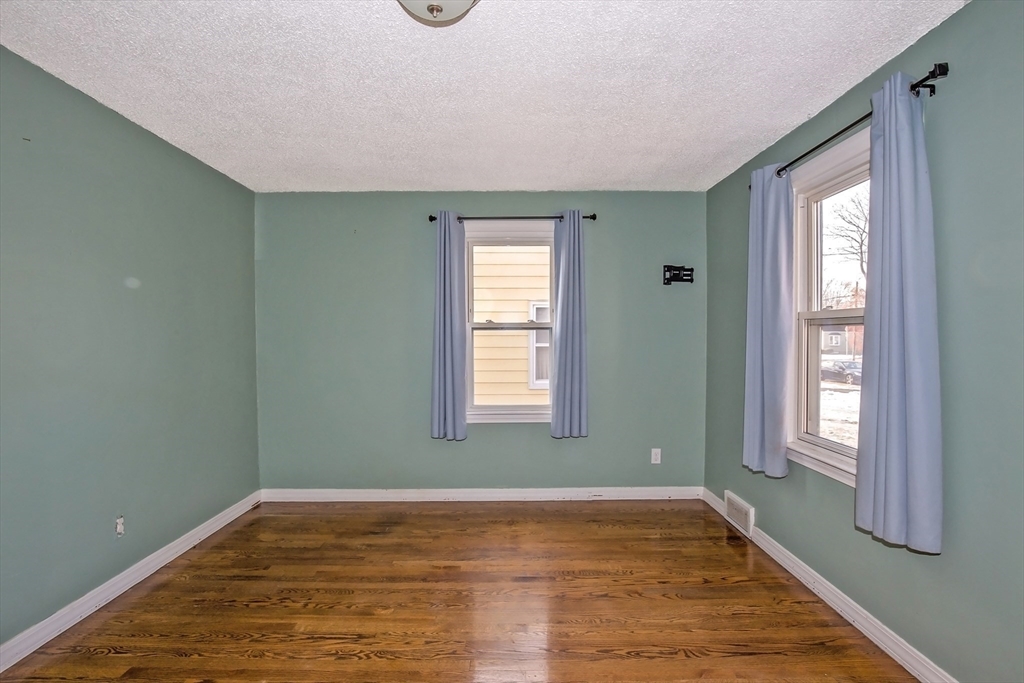 65 Garland Street Springfield, MA 01118 - Photo 23 of 39 a view of empty room with wooden floor and fan