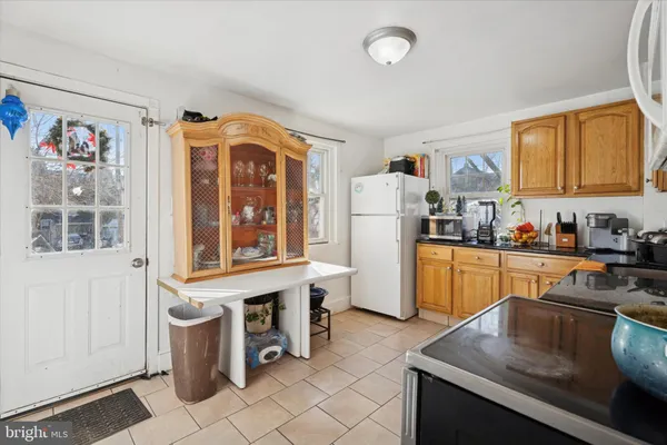 a kitchen with a refrigerator and a stove top oven