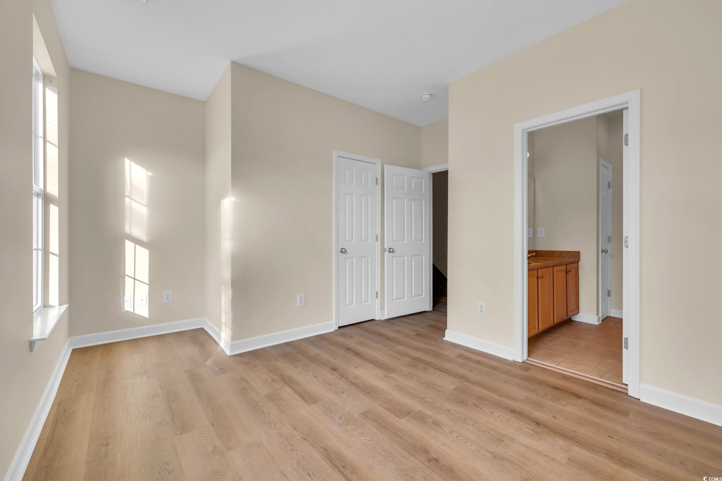 945 Rosencrans Lane, Unit B Myrtle Beach, SC 29577 - Photo 15 of 32 Unfurnished bedroom featuring light wood finished floors and connected bathroom