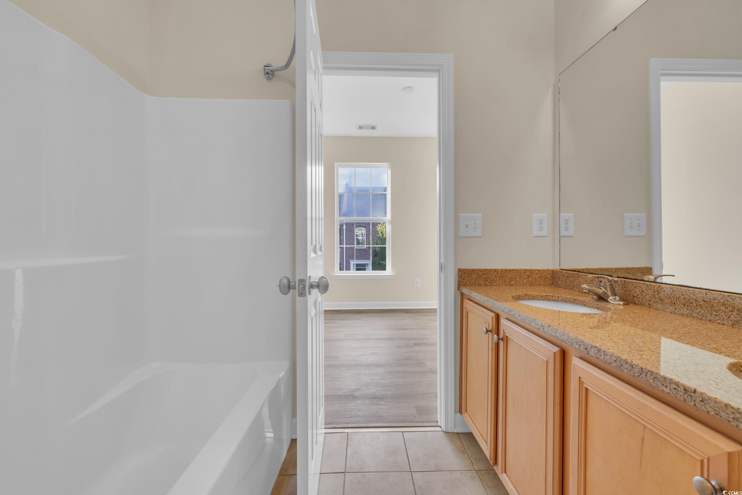 945 Rosencrans Lane, Unit B Myrtle Beach, SC 29577 - Photo 17 of 32 Full bathroom with vanity, tile patterned flooring, and tub / shower combination