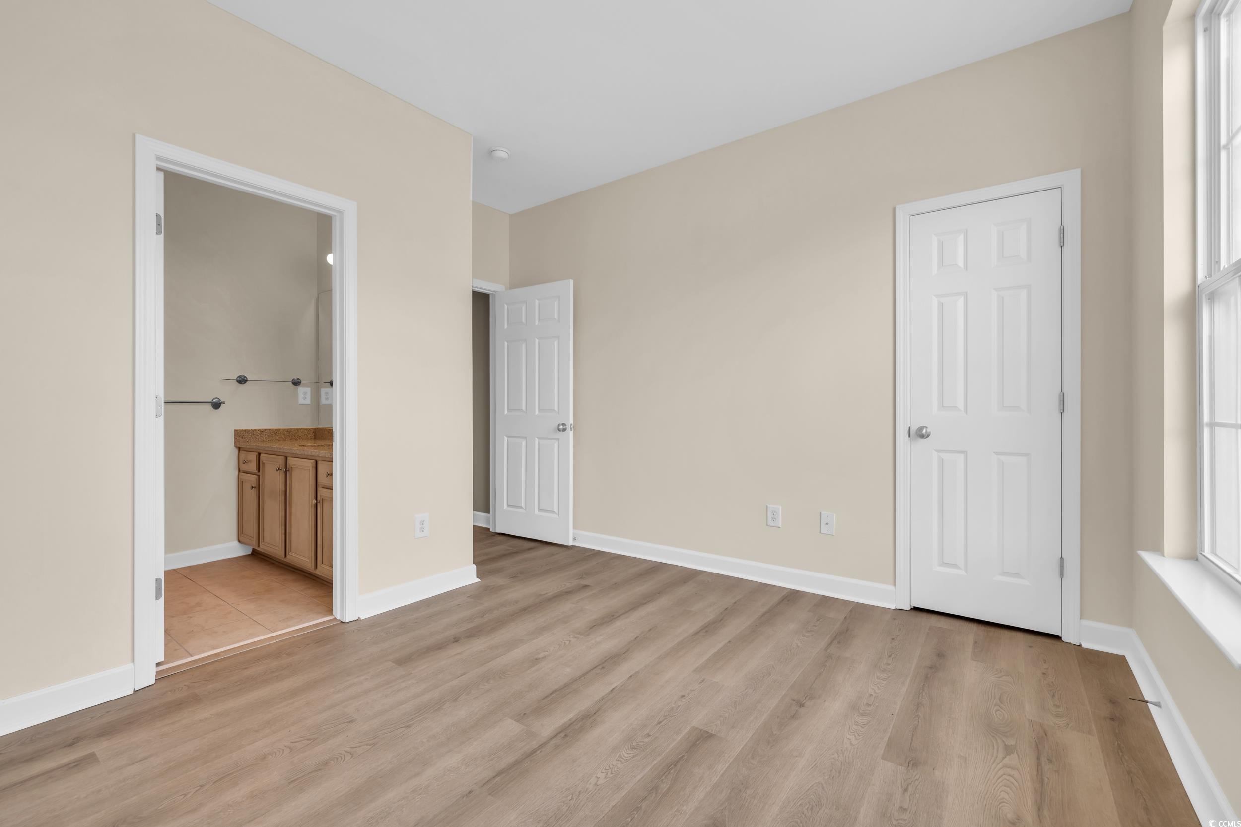 945 Rosencrans Lane, Unit B Myrtle Beach, SC 29577 - Photo 20 of 32 Unfurnished bedroom featuring light wood finished floors and ensuite bathroom