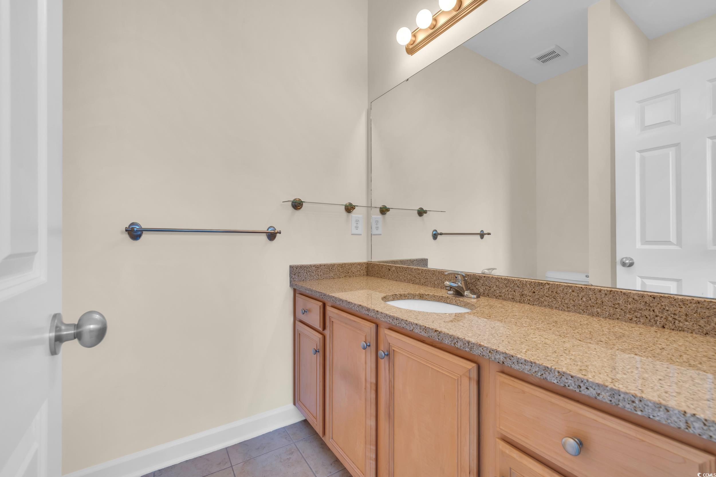 945 Rosencrans Lane, Unit B Myrtle Beach, SC 29577 - Photo 22 of 32 Bathroom featuring vanity and tile patterned flooring