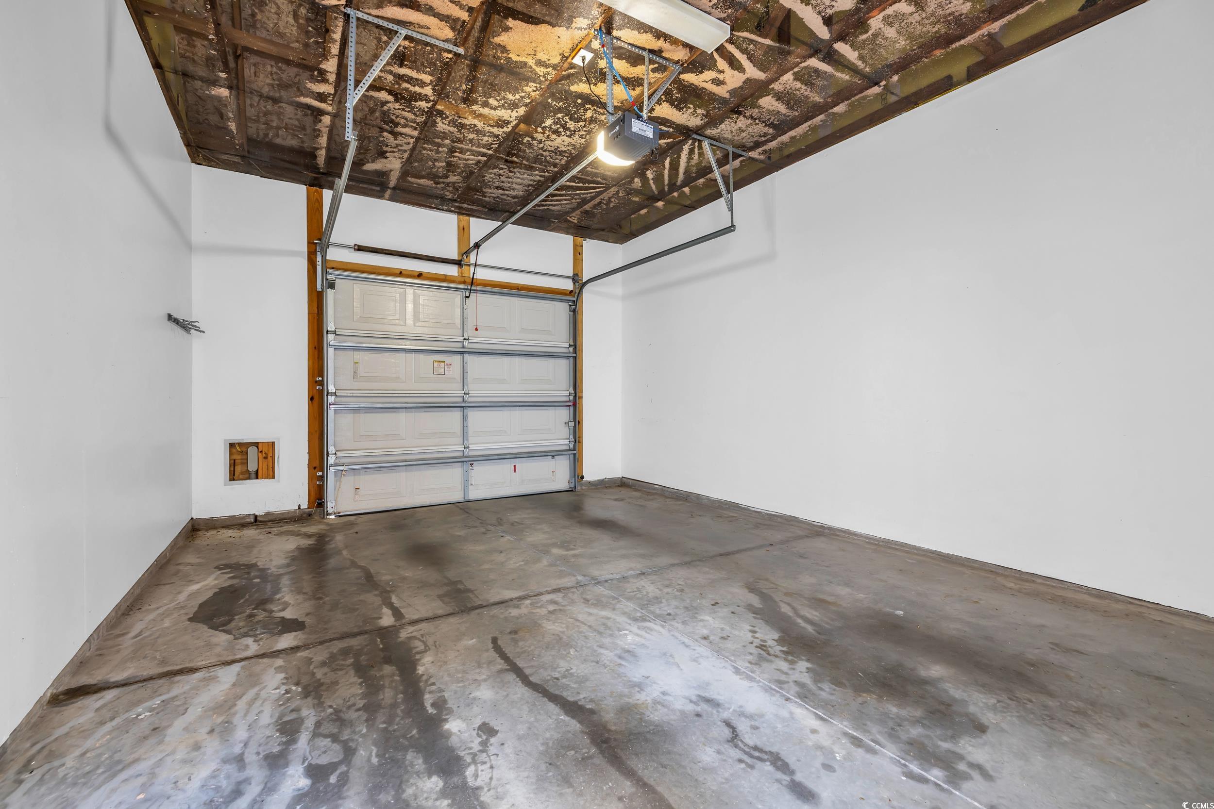 945 Rosencrans Lane, Unit B Myrtle Beach, SC 29577 - Photo 25 of 32 Garage featuring a garage door opener