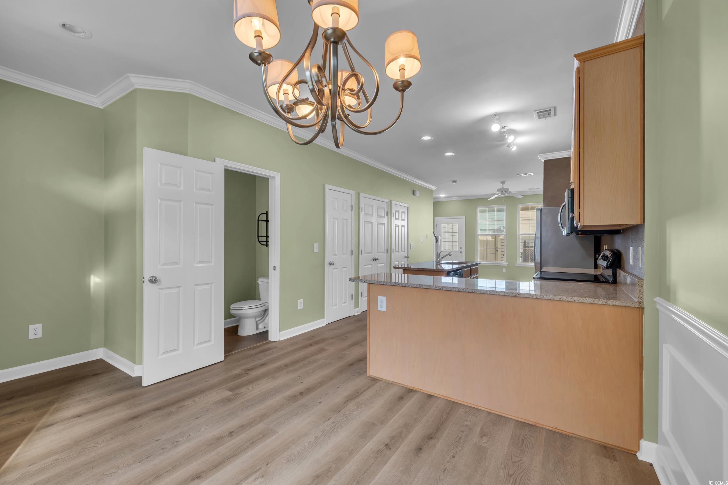 945 Rosencrans Lane, Unit B Myrtle Beach, SC 29577 - Photo 7 of 32 Kitchen featuring crown molding, a chandelier, light wood-style flooring, a peninsula, and recessed lighting