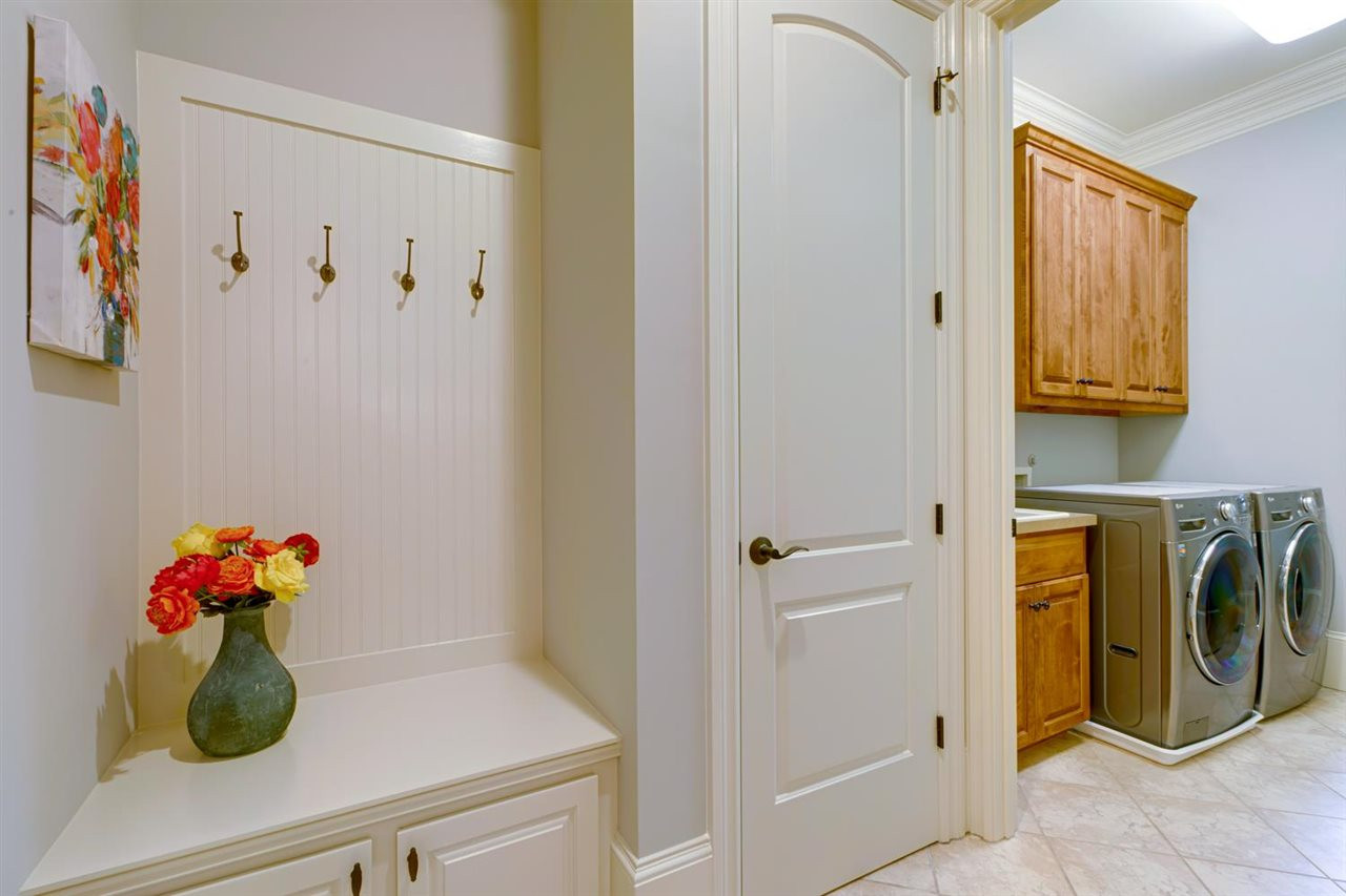 1317 Caistor Lane Raleigh, NC 27614 - Photo 12 of 24 There's a 4 CAR garage with EPOXY flooring. You enter into this great MUD room and Laundry room with a sink- so convenient and there is even a toilet room - what a great feature! The washer & dryer convey and if you want bases they are in the attic. Mud/Laundry Room