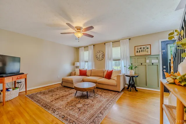 a dining room with furniture a chandelier and wooden floor