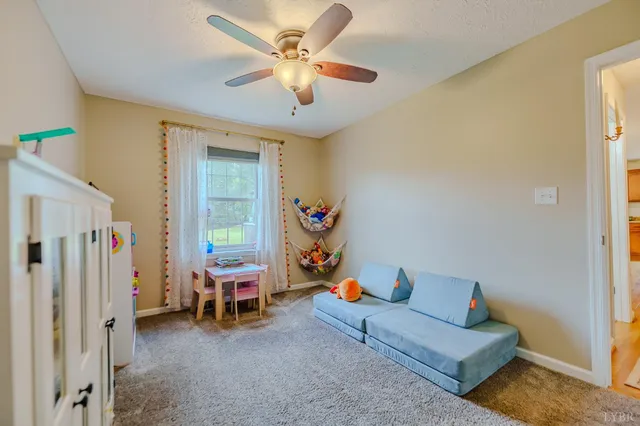 a front view of a house with a yard and lake view