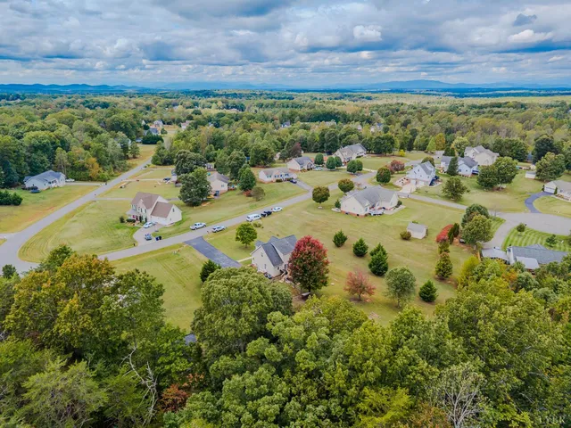 an aerial view of a house with garden space and swimming pool