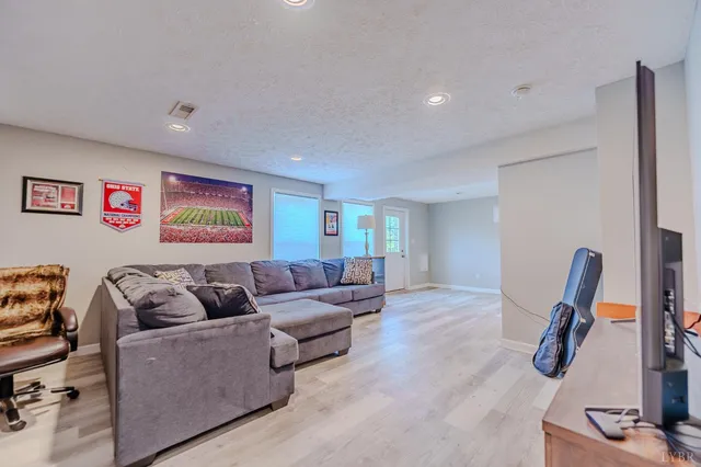 a view of a swimming pool with an outdoor seating and a yard