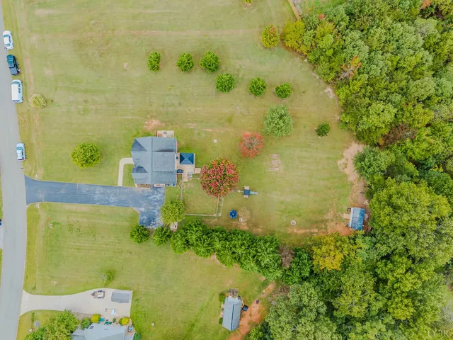 a kitchen with a sink appliances wooden floor and a view of living room