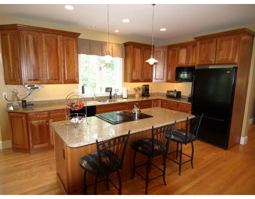 18 Corn Road Bolton, MA 01740 - Photo 4 of 12 a kitchen with stainless steel appliances granite countertop a table chairs sink refrigerator and cabinets