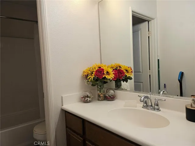a bathroom with a sink vanity and a mirror