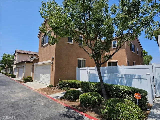 a tree in front of a white house