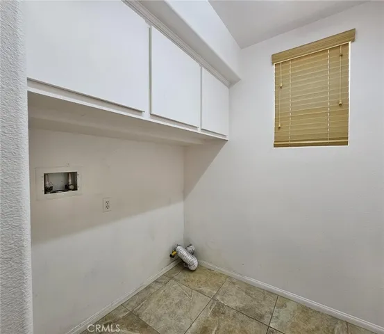 a view of storage and utility room with closet
