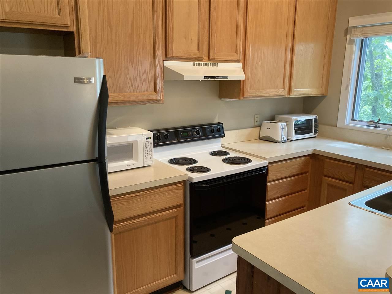409 3 Ridges Roseland, VA 22967 - Photo 2 of 19 a kitchen with a white stove top oven and sink