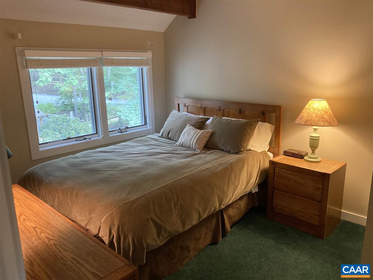 409 3 Ridges Roseland, VA 22967 - Photo 8 of 19 a bed sitting in a bedroom next to a window