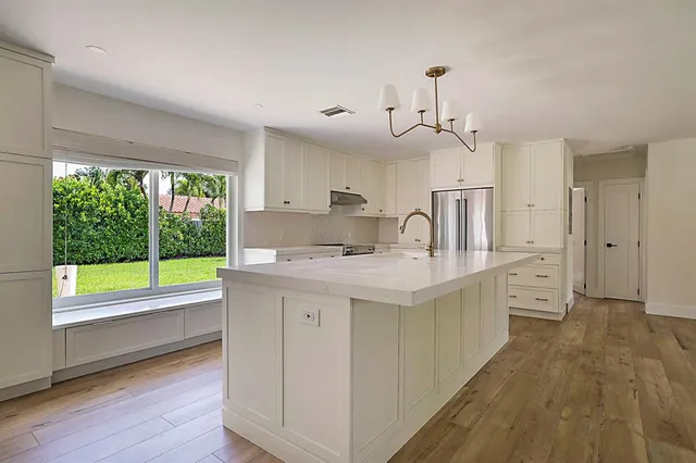 a kitchen with cabinets and stainless steel appliances