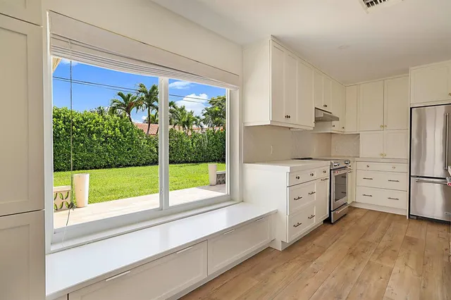 a kitchen with granite countertop white cabinets and white appliances