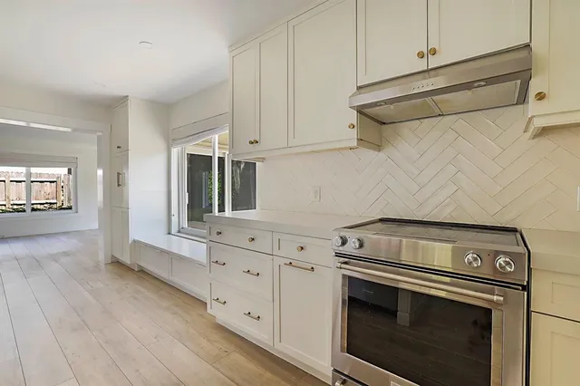 a kitchen with a sink cabinets and wooden floor