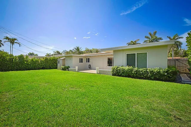 a view of a porch with furniture and a yard