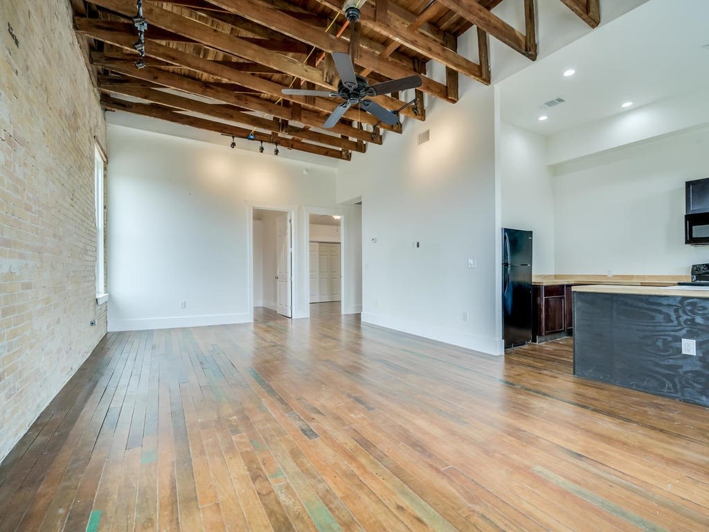 110 South Main Street, Unit 205 Elgin, TX 78621 - Photo 7 of 20 a view of a room with wooden floor and a ceiling fan