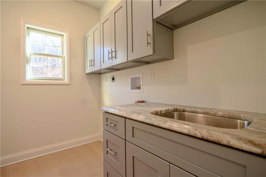 306 Hunters Crossing Canonsburg, PA 15317 - Photo 12 of 28 a kitchen with granite countertop white cabinets and a sink