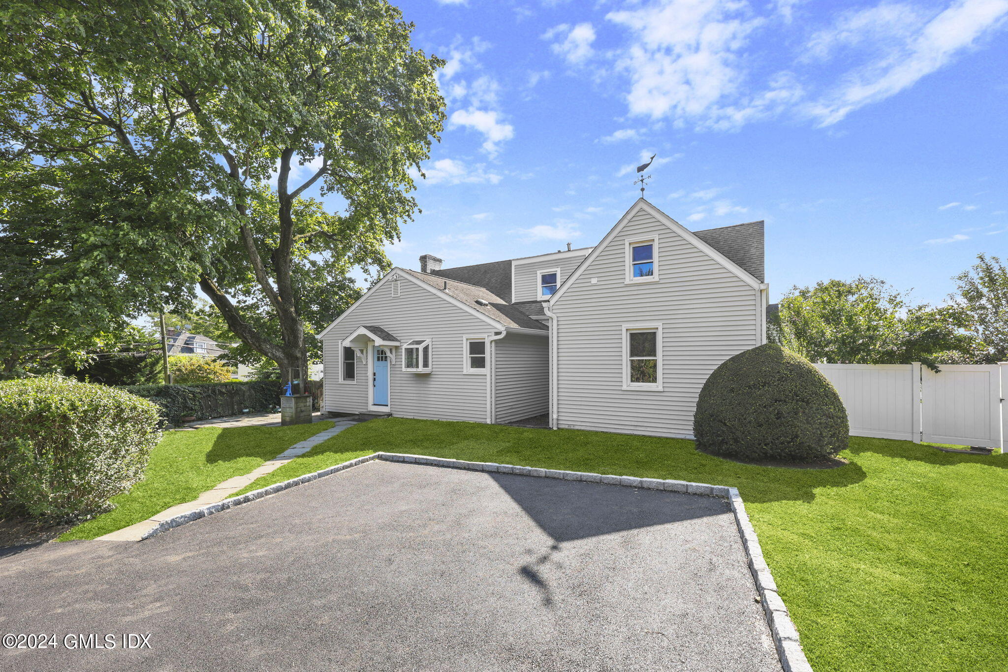 109 Byram Road, Unit B Greenwich, CT 06830 - Photo 1 of 25 a front view of a house with a garden and yard