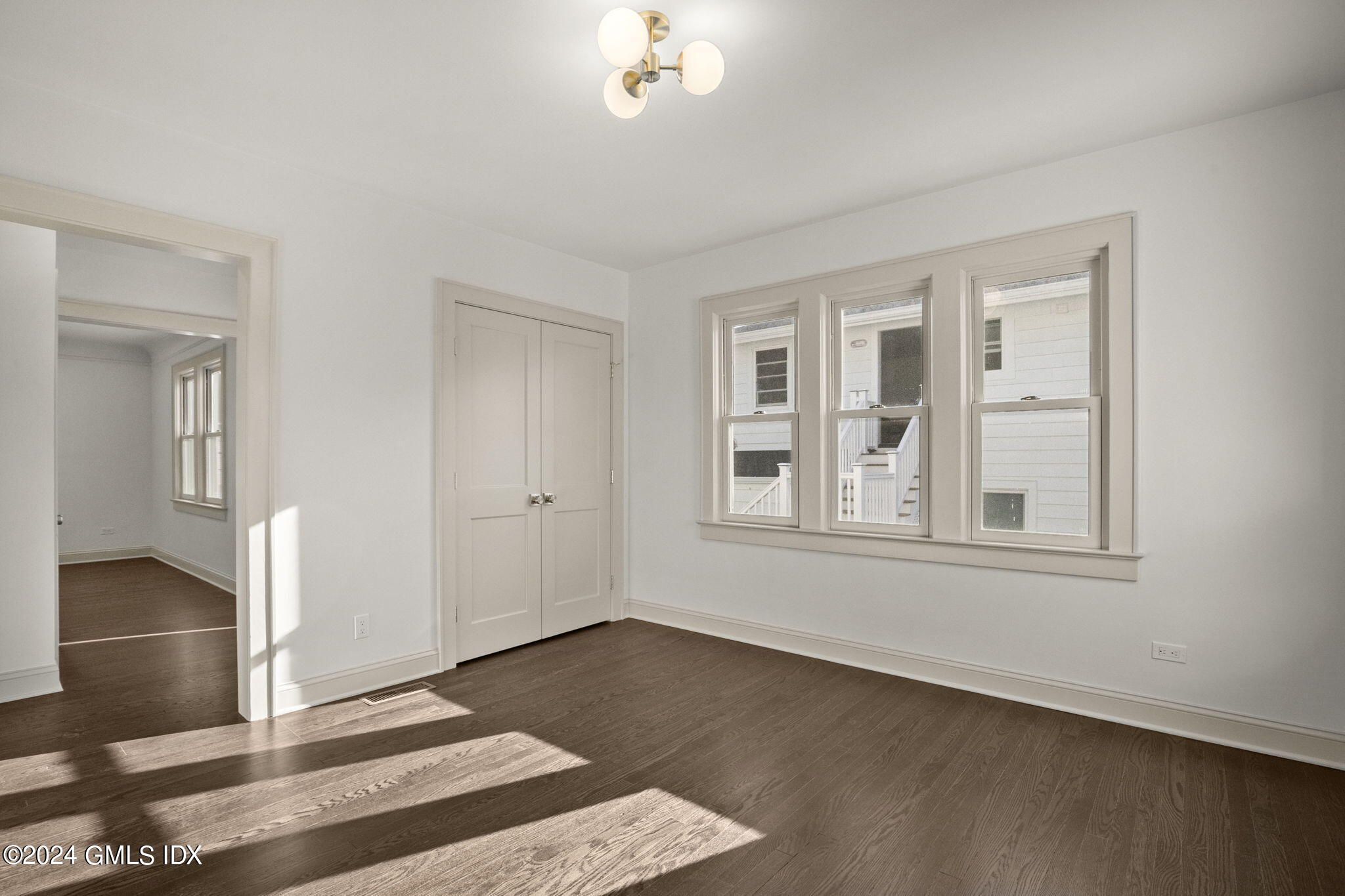 109 Byram Road, Unit B Greenwich, CT 06830 - Photo 11 of 25 an empty room with wooden floor and windows