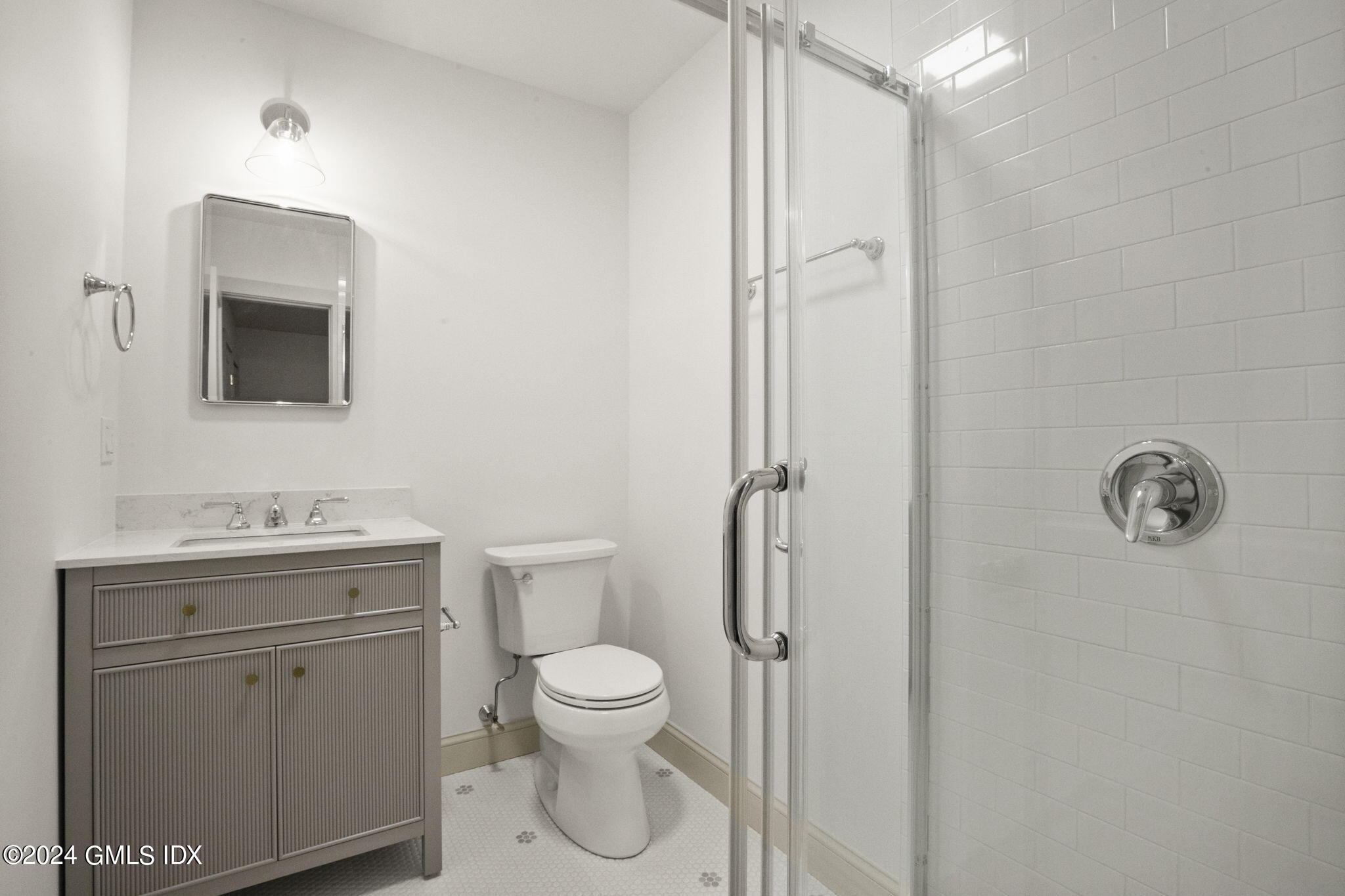 109 Byram Road, Unit B Greenwich, CT 06830 - Photo 14 of 25 a bathroom with a toilet a sink and mirror