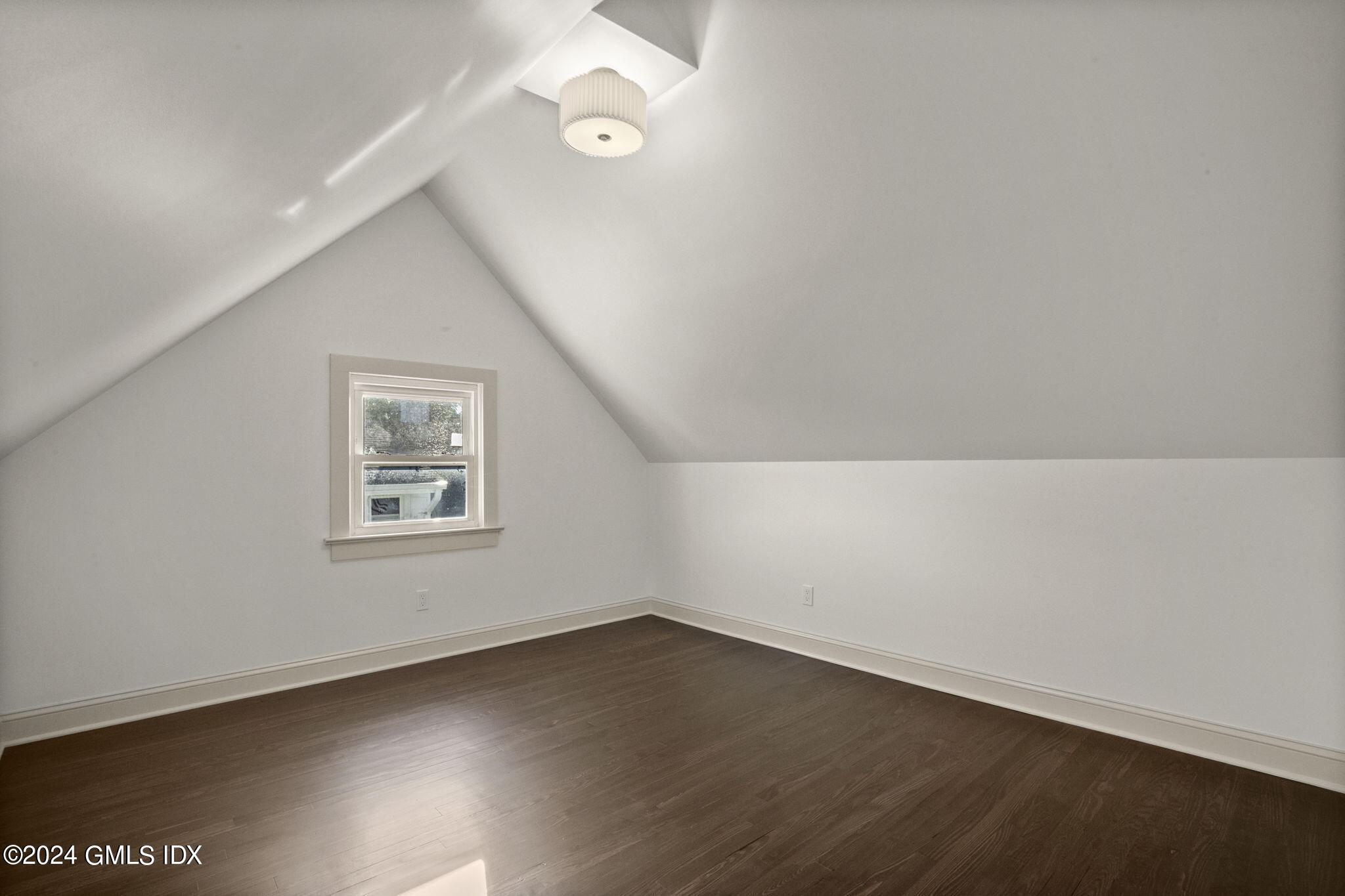 109 Byram Road, Unit B Greenwich, CT 06830 - Photo 19 of 25 an empty room with wooden floor and windows