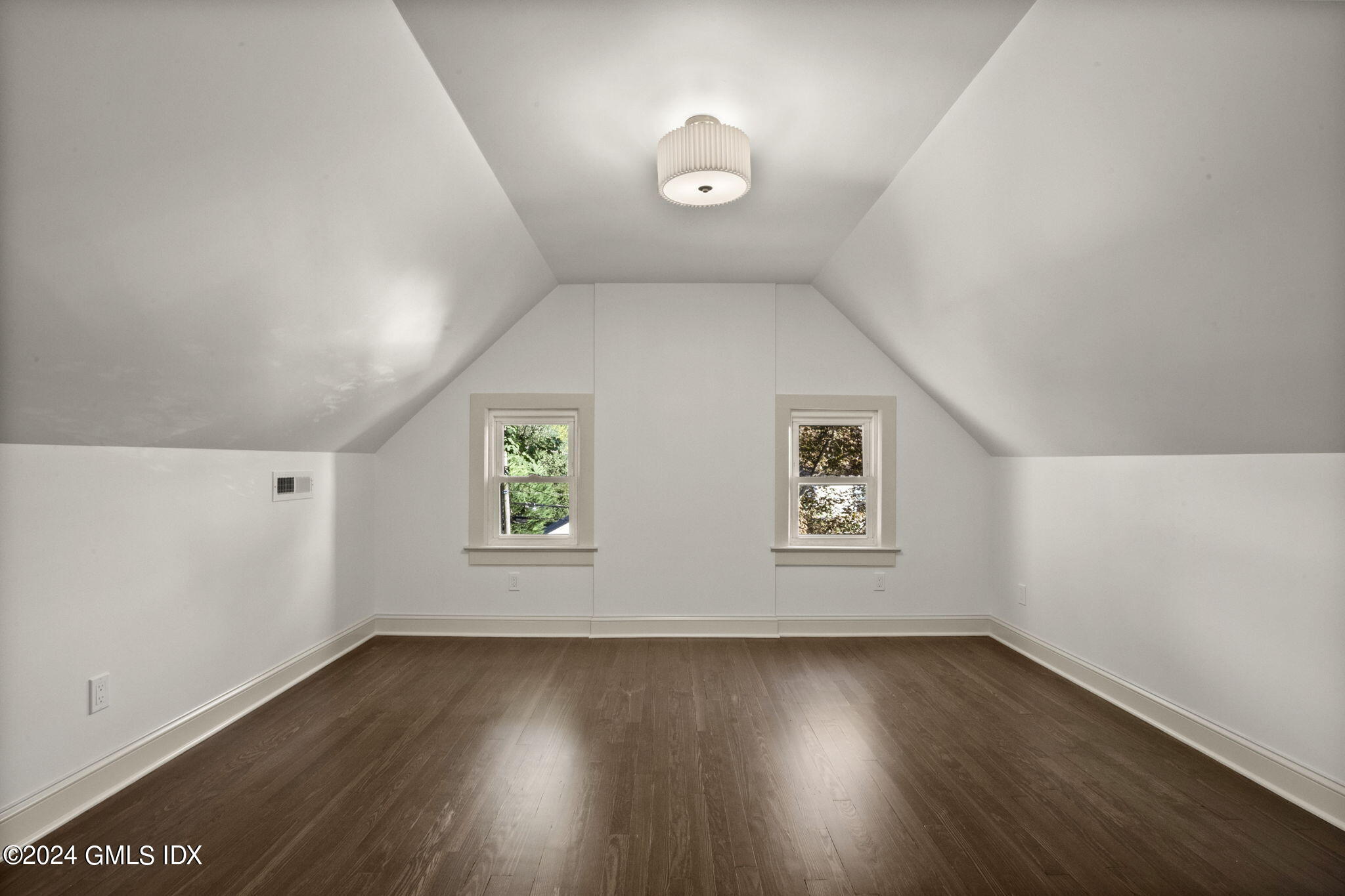 109 Byram Road, Unit B Greenwich, CT 06830 - Photo 21 of 25 an empty room with wooden floor and windows
