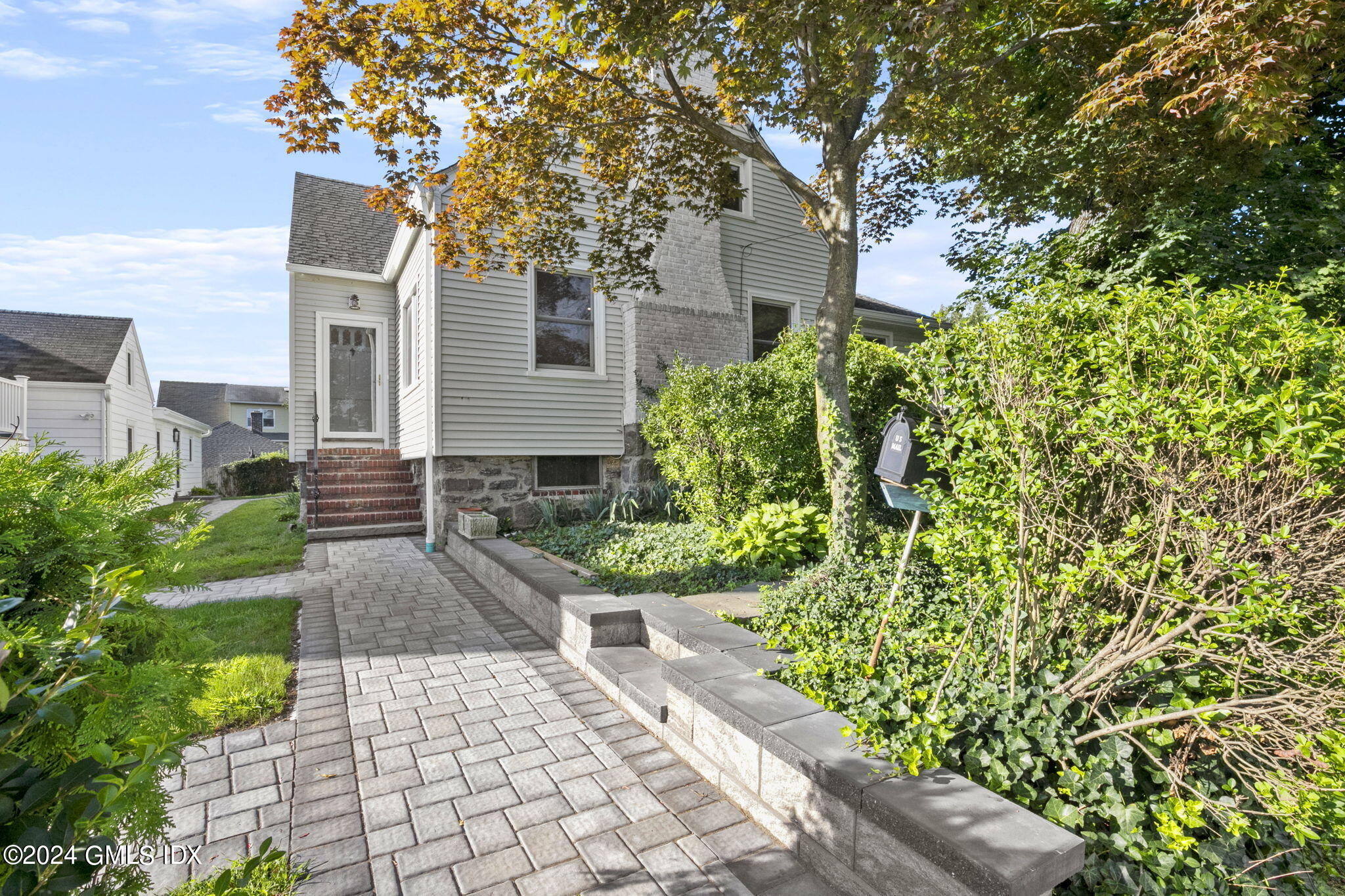 109 Byram Road, Unit B Greenwich, CT 06830 - Photo 23 of 25 a front view of a house with a yard and potted plants