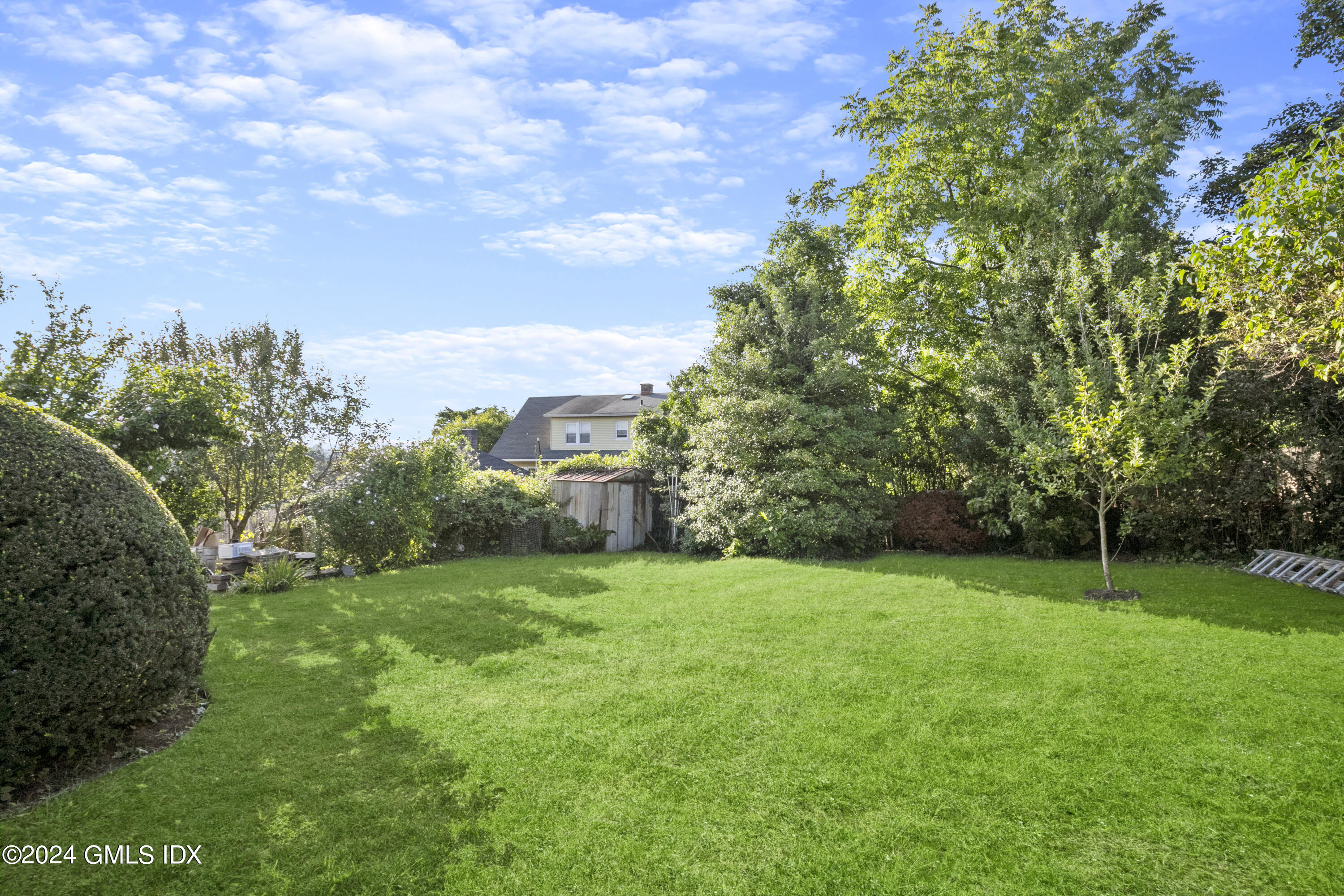 109 Byram Road, Unit B Greenwich, CT 06830 - Photo 25 of 25 a view of a green yard with a house