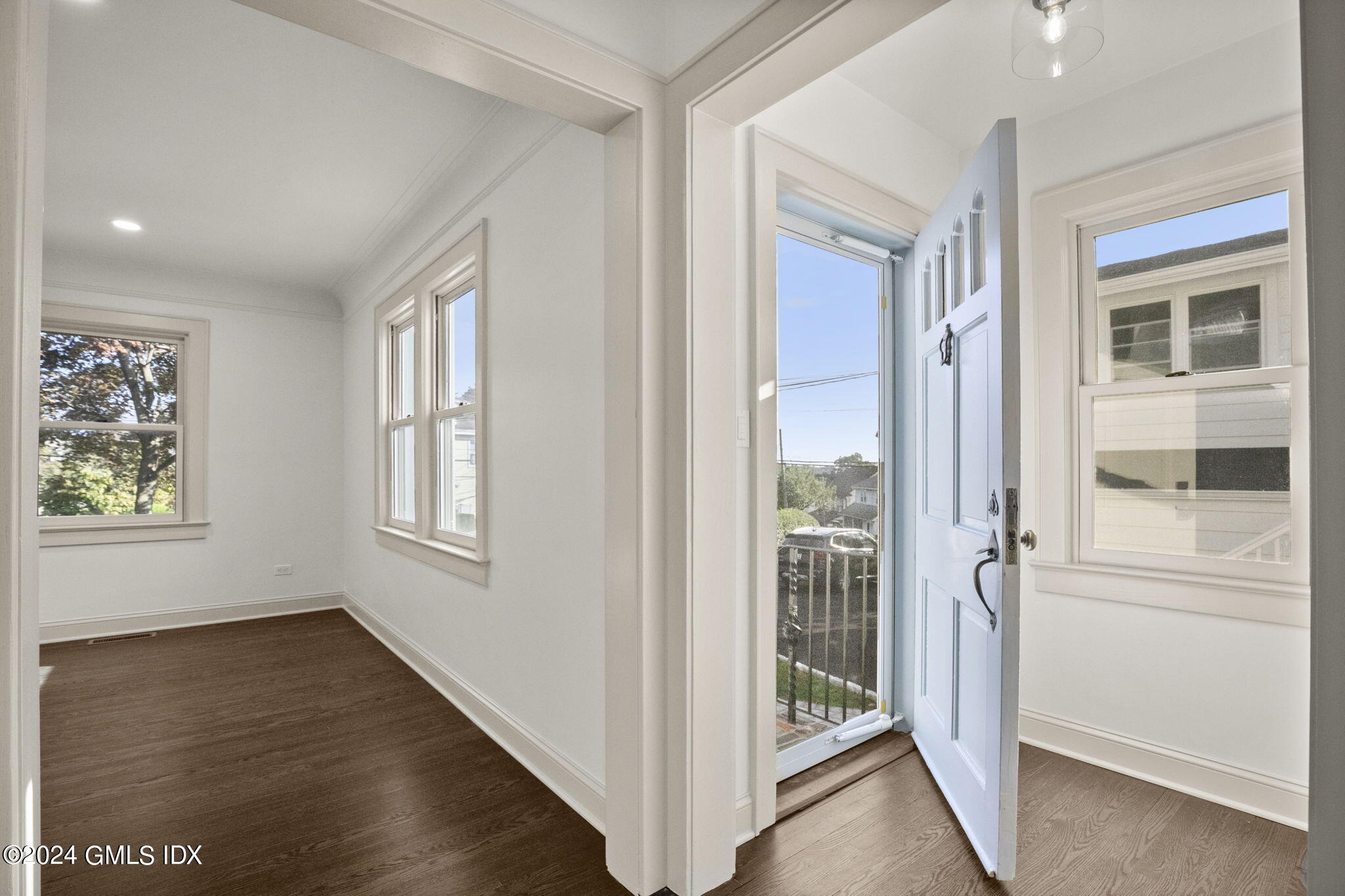 109 Byram Road, Unit B Greenwich, CT 06830 - Photo 3 of 25 a view of an entryway with wooden floor and windows