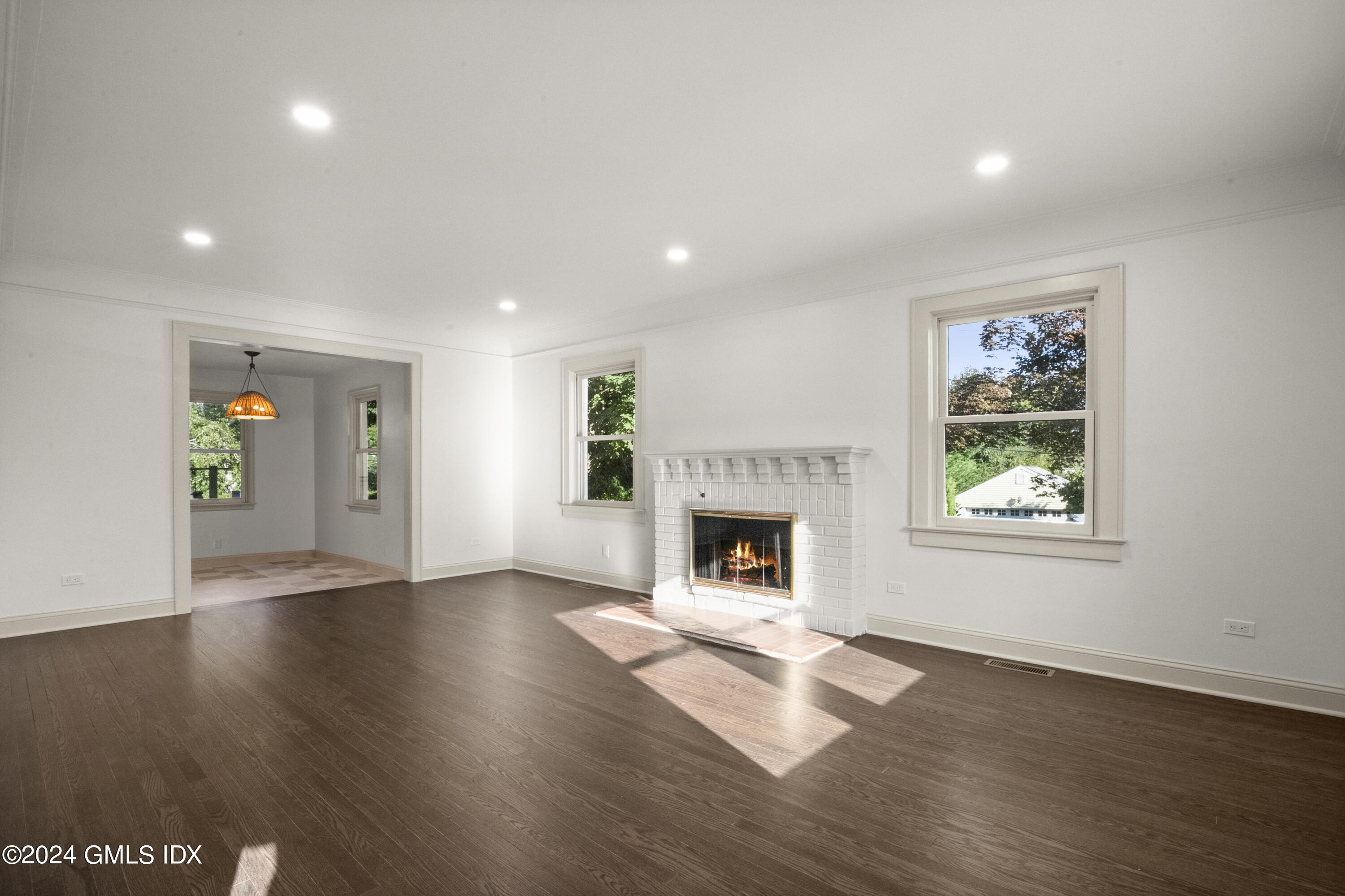 109 Byram Road, Unit B Greenwich, CT 06830 - Photo 5 of 25 a view of empty room with wooden floor and fireplace