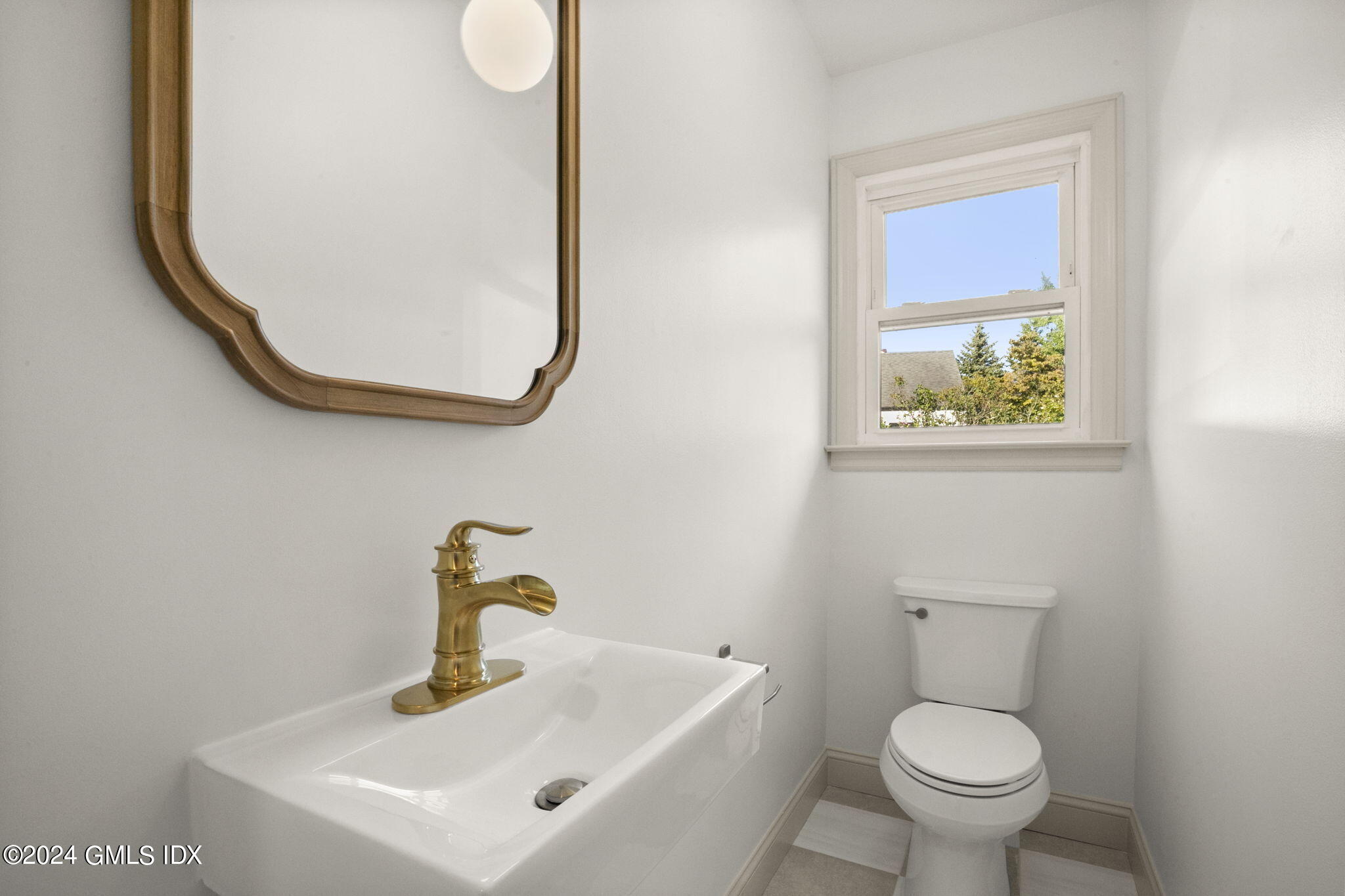 109 Byram Road, Unit B Greenwich, CT 06830 - Photo 10 of 25 a bathroom with a toilet sink and mirror