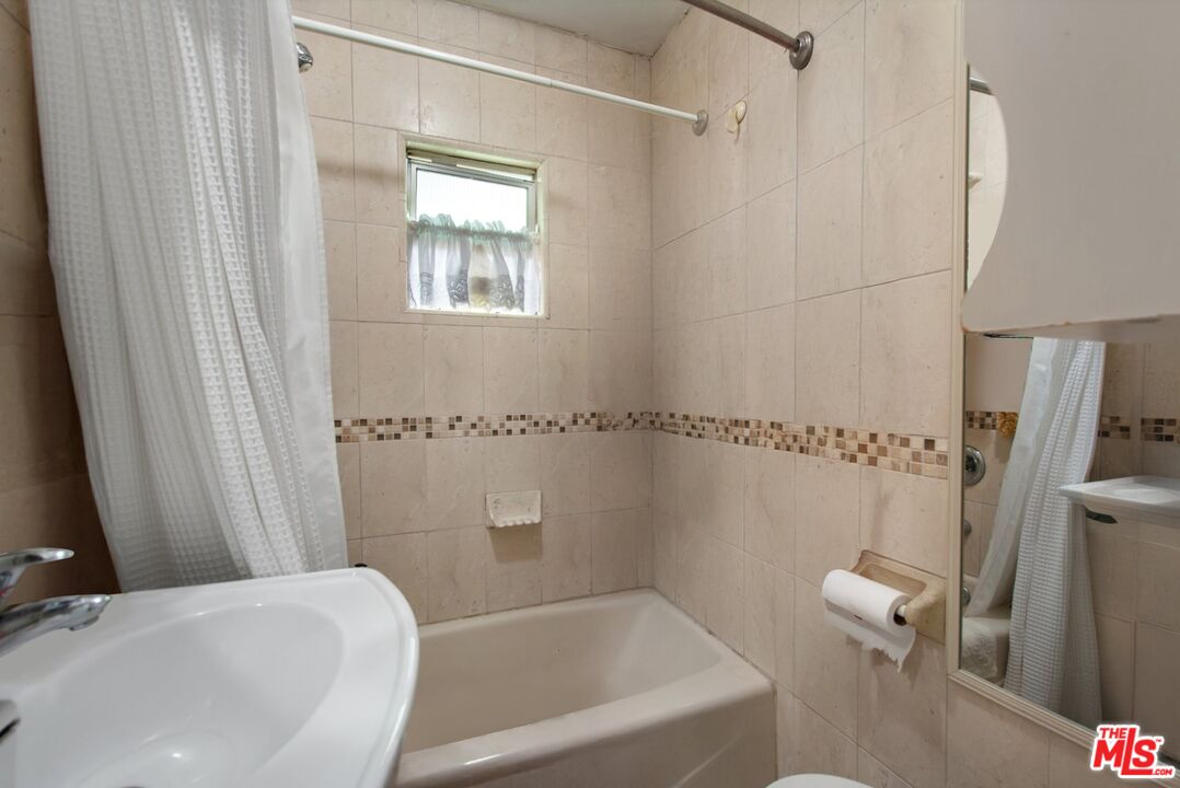 4713 Clinton Street Los Angeles, CA 90004 - Photo 15 of 25 a bathroom with a sink a toilet and a bathtub