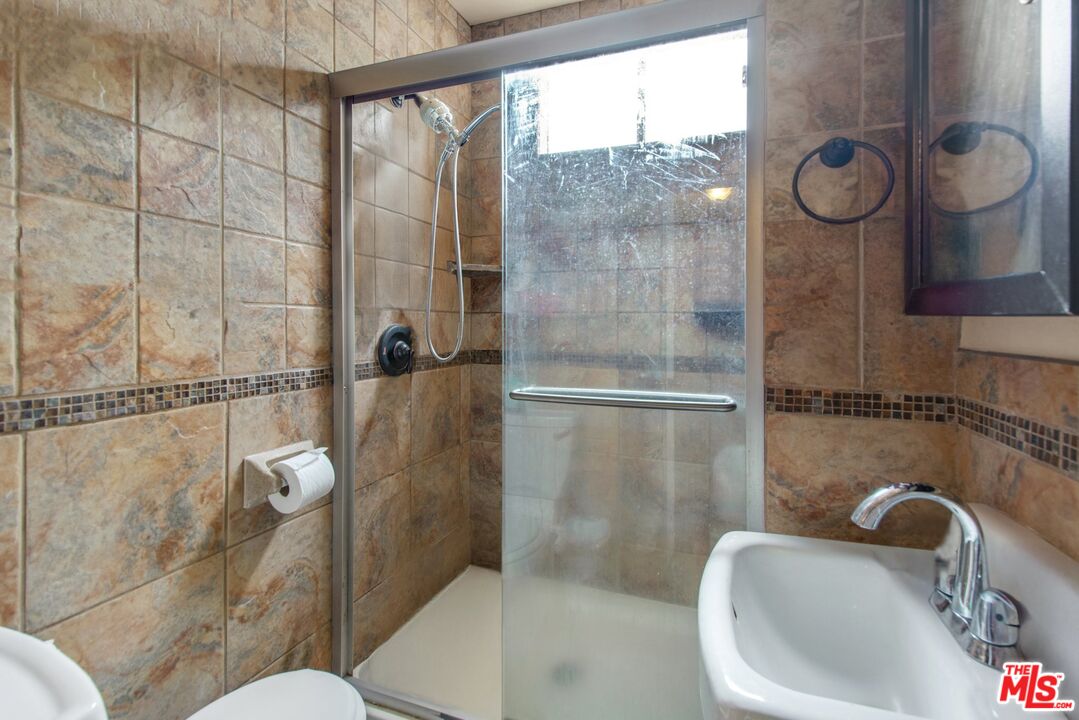 4713 Clinton Street Los Angeles, CA 90004 - Photo 8 of 25 a bathroom with a sink a toilet and shower