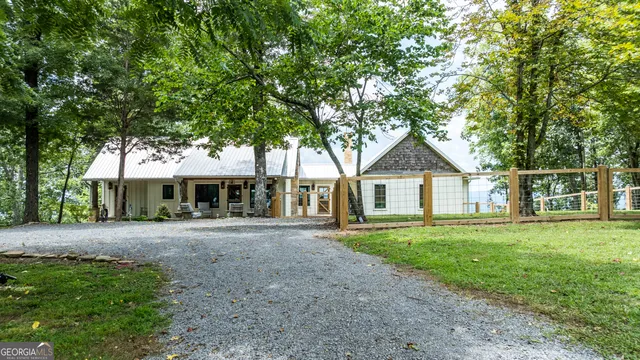 a front view of a house with a yard and trees