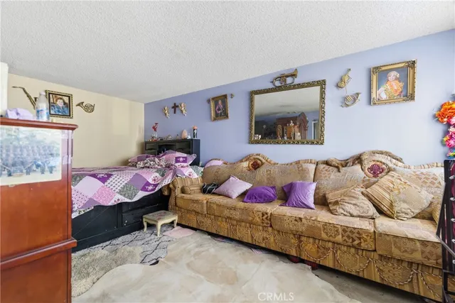 a bedroom with a bed and a painting on the wall